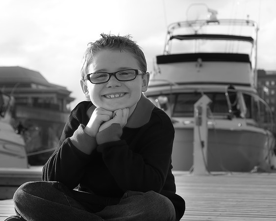 a boy in front of a boat, marina park, lake superior in Thunder Bay